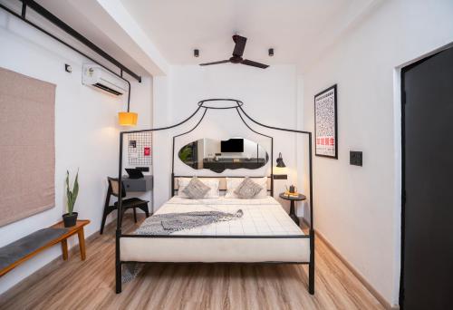 a bedroom with a bed with a metal frame at One-Off Dashashwamedh in Varanasi