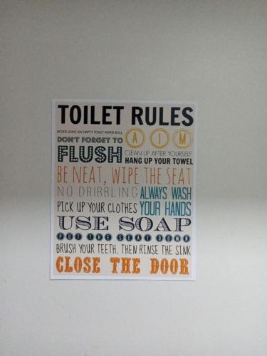 a sign on a wall that reads toilet rules at Cheers SMDC Condominium in Marilao