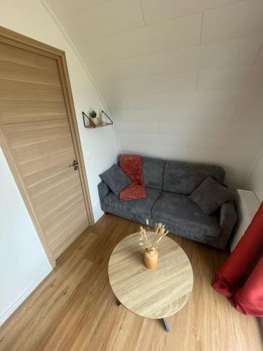 a living room with a couch and a table at Ecolodge in Trébeurden