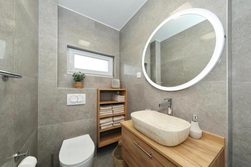 a bathroom with a sink and a mirror at Apartmani Cicak in Vir