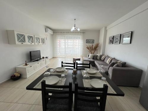 a living room with a table and a couch at Moon City Center Apartment in Shkodër