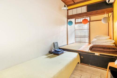 a bedroom with a bunk bed with a laptop on it at Villa Sacra in Kamakura
