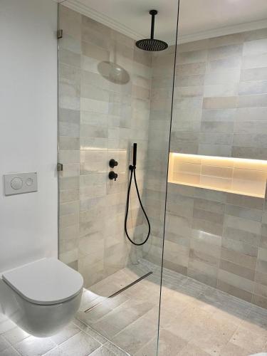 a bathroom with a shower with a toilet at Charming of Olhao2 in Olhão