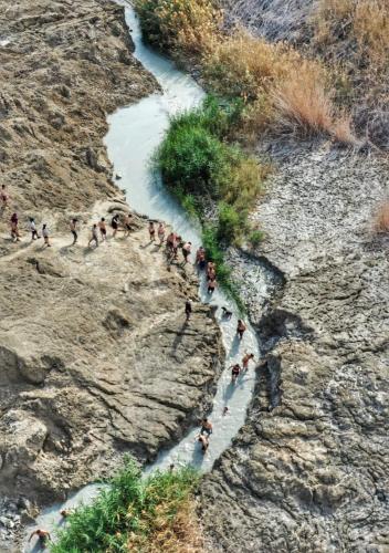 a group of people walking along a river at Patricia & Eilam house in Ein Gedi