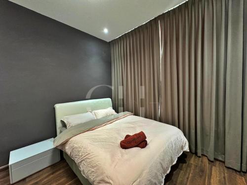 a bedroom with a bed with two red towels on it at Kuching Rex 2 bedrooms for 4 pax in Kuching
