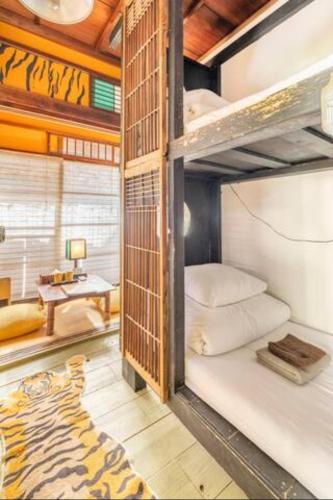 a room with two bunk beds and a table at Villa Sacra in Kamakura