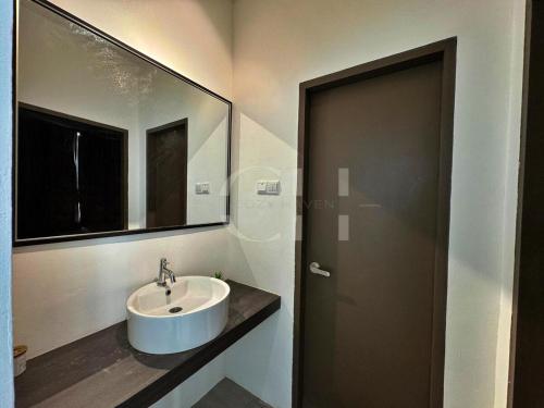 a bathroom with a sink and a mirror at Kuching Rex 2 bedrooms for 4 pax in Kuching
