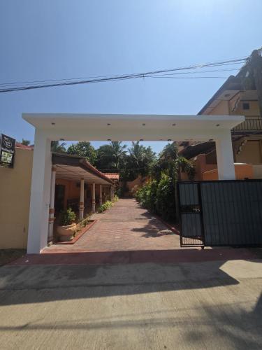an empty walkway between two buildings with a gate at Motel Apple Five in Trincomalee