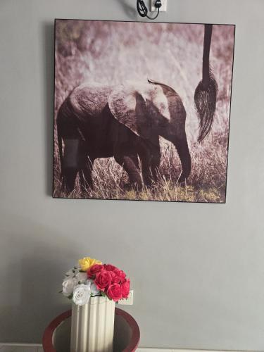 a picture of an elephant and a bird on a wall at Motel Apple Five in Trincomalee