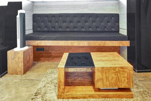 1 cama con banco y 1 mesa en una habitación en Super Collection O KEYS ELITE, en Vijayawada