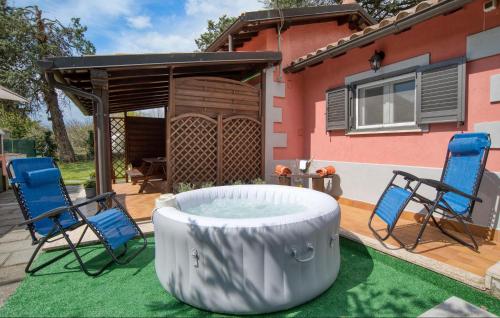 a backyard with two chairs and a hot tub at Cozy Home In Montefiascone in Montefiascone