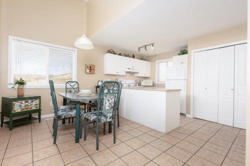 a kitchen and dining room with a table and chairs at Paradise Canyon Golf Resort - Luxury Condo U407 in Lethbridge