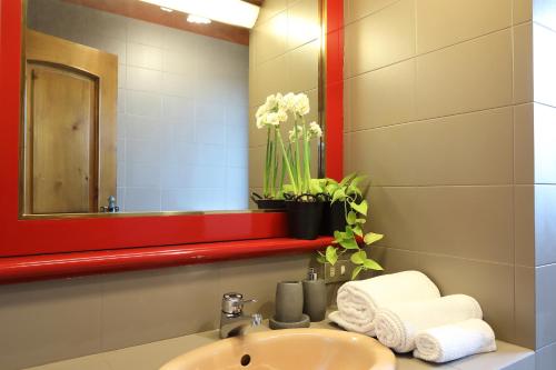 a bathroom with a sink and a mirror at Viscardo in Tarcento