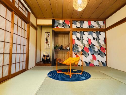 a chair sitting on a rug in a room at Lucky you! TATEISHI in Tokyo