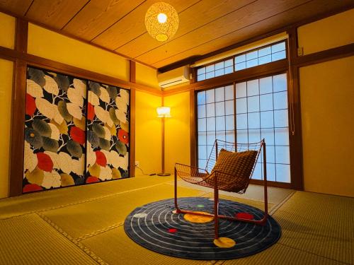 a room with a rocking chair in a room with windows at Lucky you! TATEISHI in Tokyo