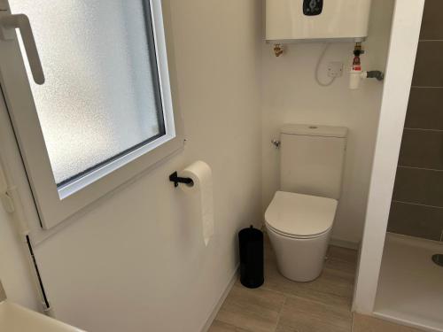 a small bathroom with a toilet and a window at Ker-Ysa Finistère in Plomodiern