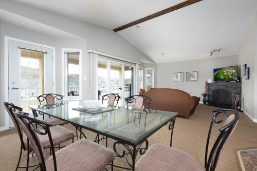 a dining room with a table and chairs and a couch at Paradise Canyon Golf Resort - Signature Villa 382 in Lethbridge