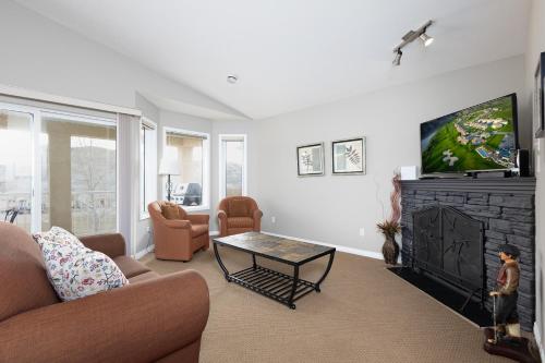 a living room with a couch and a flat screen tv at Paradise Canyon Golf Resort - Signature Villa 382 in Lethbridge