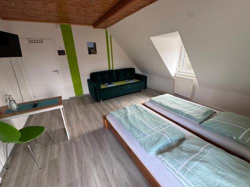 a living room with two beds and a couch at Rennsteigscheune in Steinbach am Wald