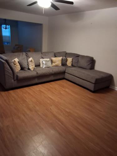 a couch in a living room with a wooden floor at Walton Hill in Fairburn