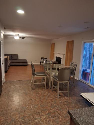 a living room with a table and chairs and a couch at Walton Hill in Fairburn