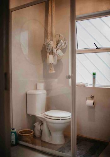 a bathroom with a toilet and a window at Clanwilliam Dam House in Clanwilliam