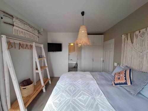 a bedroom with two bunk beds and a bathroom at Clanwilliam Dam House in Clanwilliam