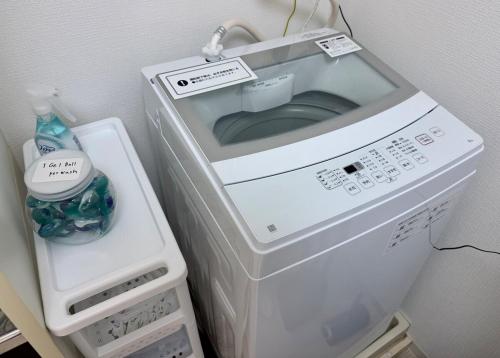 a microwave oven sitting on top of a refrigerator at ZenAbode, 5-minute walk from Taiko-dori Station, 1-minute train ride from Nagoya Station, excellent location for sightseeing in Nagoya in Nagoya