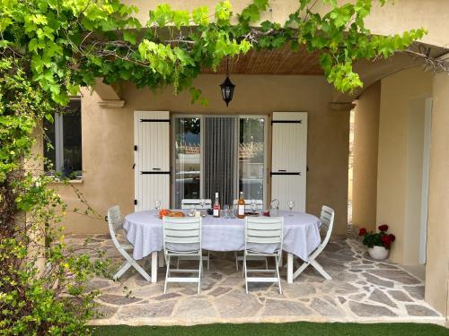 a white table and chairs on a patio at Gîte de la Dame in Condorcet