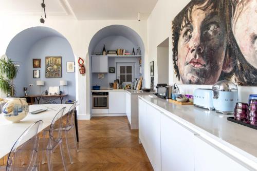 une cuisine avec un grand tableau mural dans l'établissement Comme une maison sur l'Île Saint Louis, à Paris
