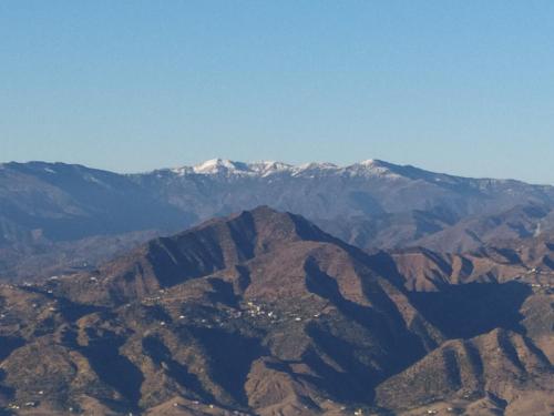 a view of a mountain range with snow capped mountains at Gite touristique bouknala in Abinane