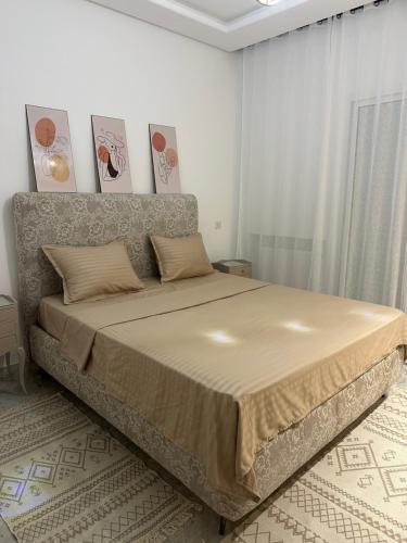 a bedroom with a large bed in a room at Luxury suite jardin de Carthage in Sidi Daoud