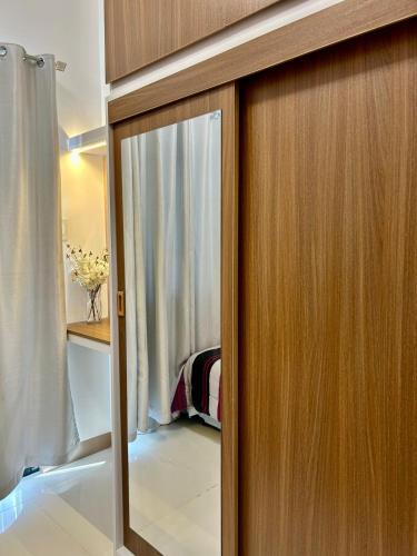 a wooden door with a window in a room at New 1BR Haven Suite Lush Residences Smart TV Netflix Hi speed internet in Manila
