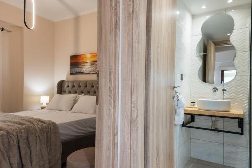 a bedroom with a bed and a sink and a mirror at Zante way villas in Alikanas