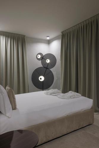 a bedroom with a large bed with two lights on it at Palazzo Bellezia Luxury Suites & Spa in Turin