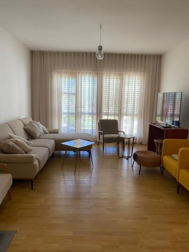 a living room with a couch and a table at Six bedroom Holiday home Matea in Ploče