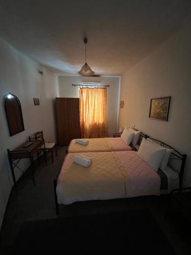 a hotel room with two beds and a window at Nianthi Apartments in Mithymna