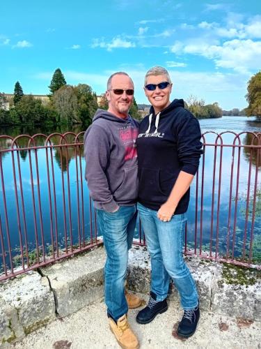 a man and woman standing in front of a body of water at Trecastle in Châlus