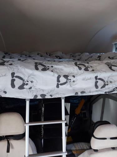 a bed with a black and white comforter on it at A vroom with a view! in Eastcote