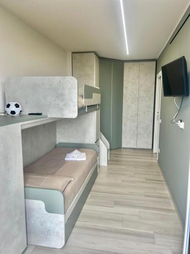 a small room with a bunk bed and a television at Residence Sunset Egadi in Marsala