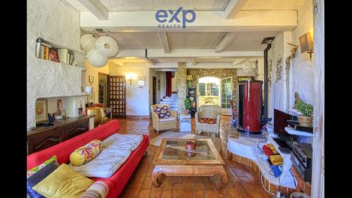 a living room with a red couch and a table at Maison de famille en Provence in Rognes