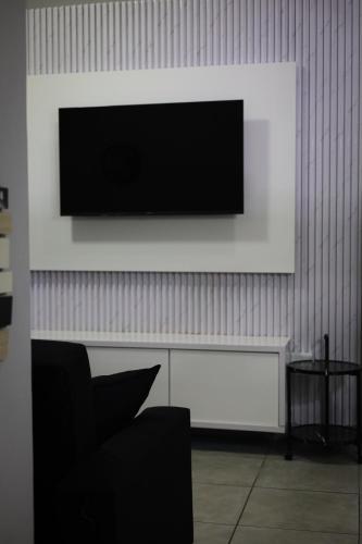 a living room with a television on a wall at Forest-Riversend in Pietermaritzburg