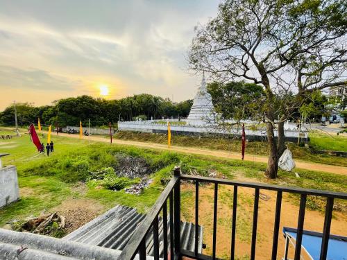 a park with a bench and a tree and a monument at Stay Lanka Guest House in Nikawatawana