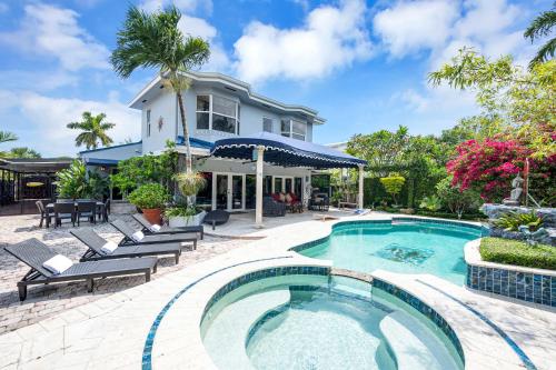 a swimming pool in front of a house at Magnificent Tropical Pool Home Miami SouthBrickell in Miami