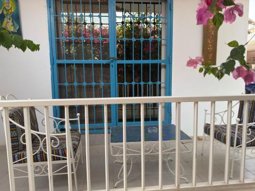 a balcony with a gate and a table and chairs at Havre De Paix in Somone
