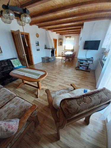 a living room with a couch and a table at Wypoczynek Kocia Góra in Dziemiany