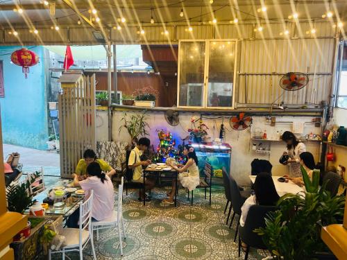 a group of people sitting at a table in a room at Cat Ba Mystery Homestay in Cat Ba