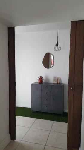 a room with a dresser and a mirror on the wall at Gîte Le BB in Chenay