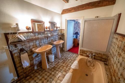 a bathroom with two sinks and a tub at Le Relais Cicero in La Flèche