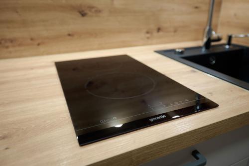 a laptop on a counter next to a sink at Ferienwohnung Kuhn in Wallbach